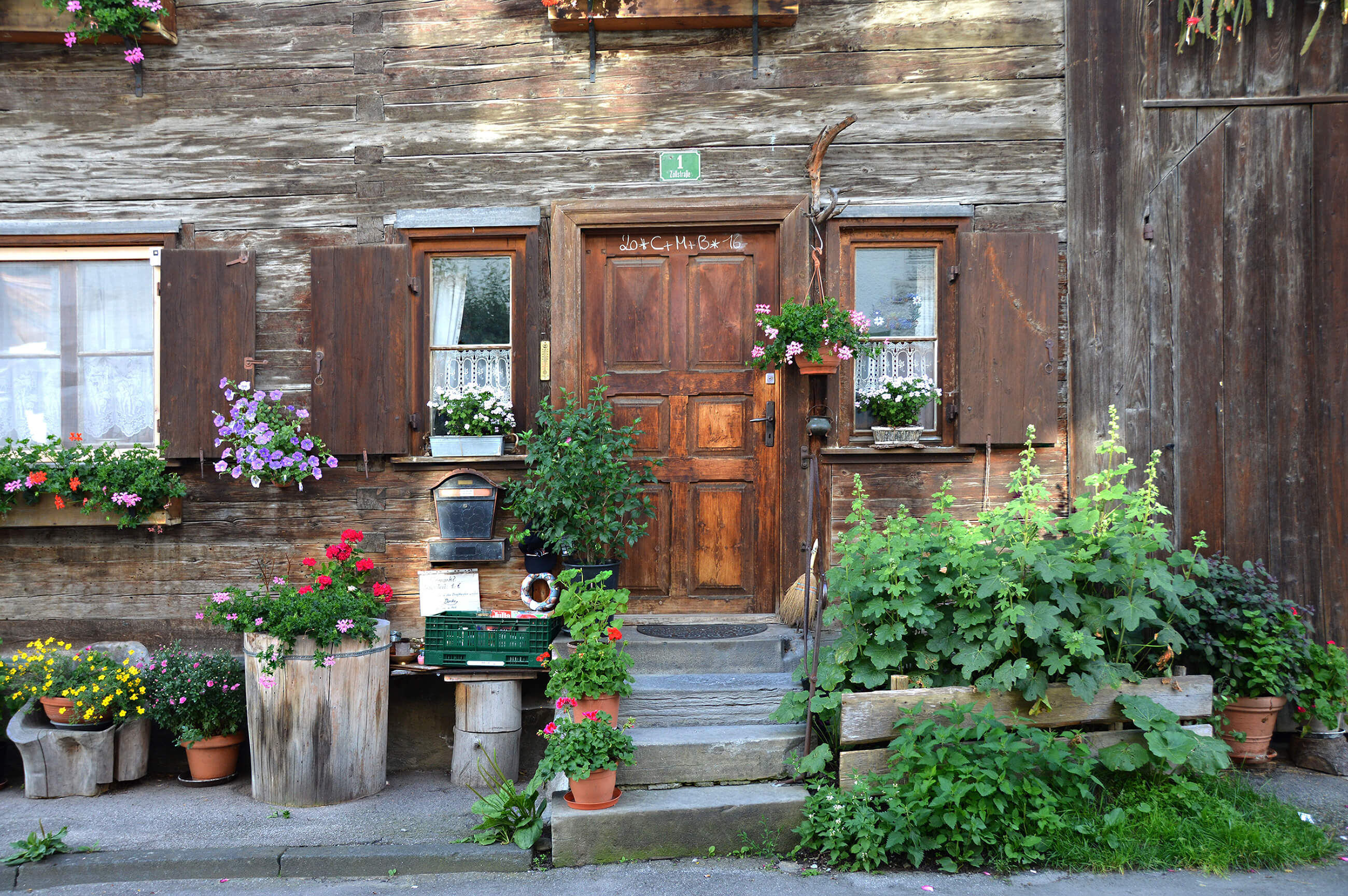 Rustic home front with a wooden door and shutters, with plant in pots. Action Property Management can provide property management for rental properties like this one! Rustic home front with a wooden door and shutters, with plant in pots. Action Property Management can provide property management for rental properties like this one!
